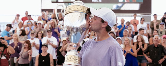 Chris Haworth kisses the championship trophy after defeating Ben Johns to take the title.