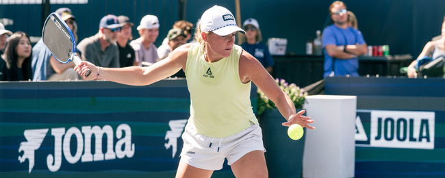 Brooke Buckner hitting a pickleball serve.