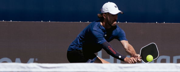 Hunter Johnson hitting a pickleball backhand.