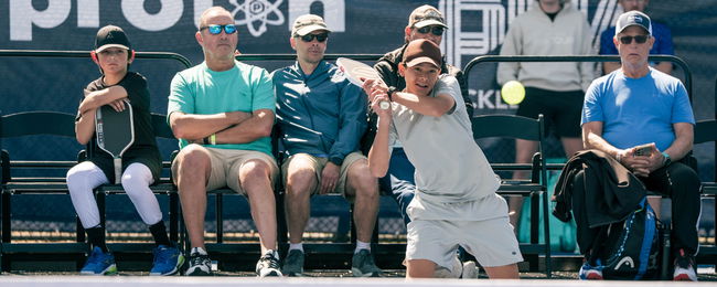 Tama Shimabukuro hitting a pickleball backhand.