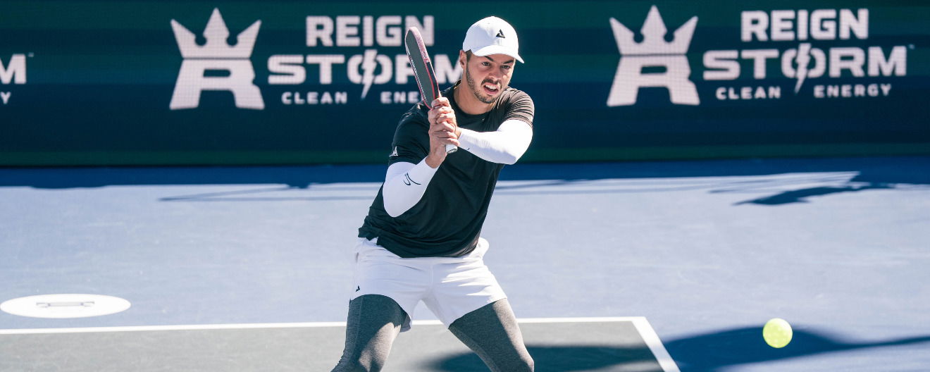 Ben Johns hitting a pickleball backhand.