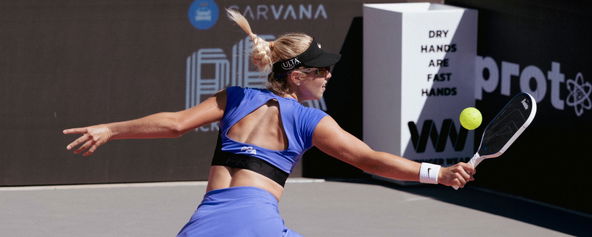Anna Leigh Waters in a purple top and skirt.