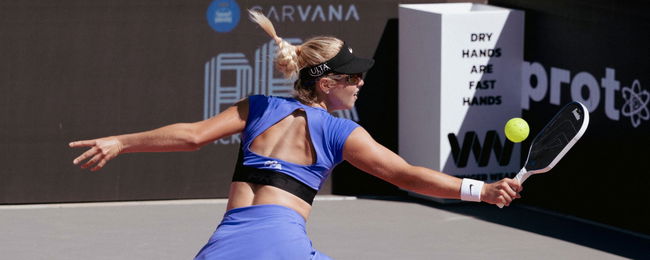 Anna Leigh Waters in a purple top and skirt.