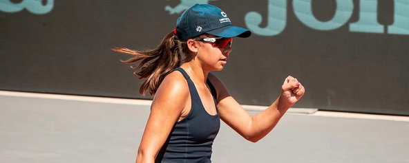 Kelly Goodnow playing pro pickleball and pumping her fist in celebration.