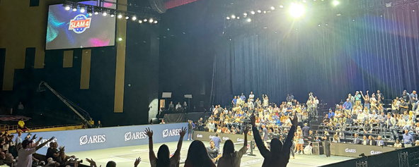 Fans standing up and cheering watching the Pickleball Slam 4