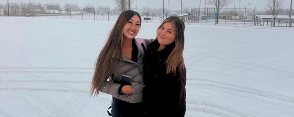 Kiora and Gio standing in the snow