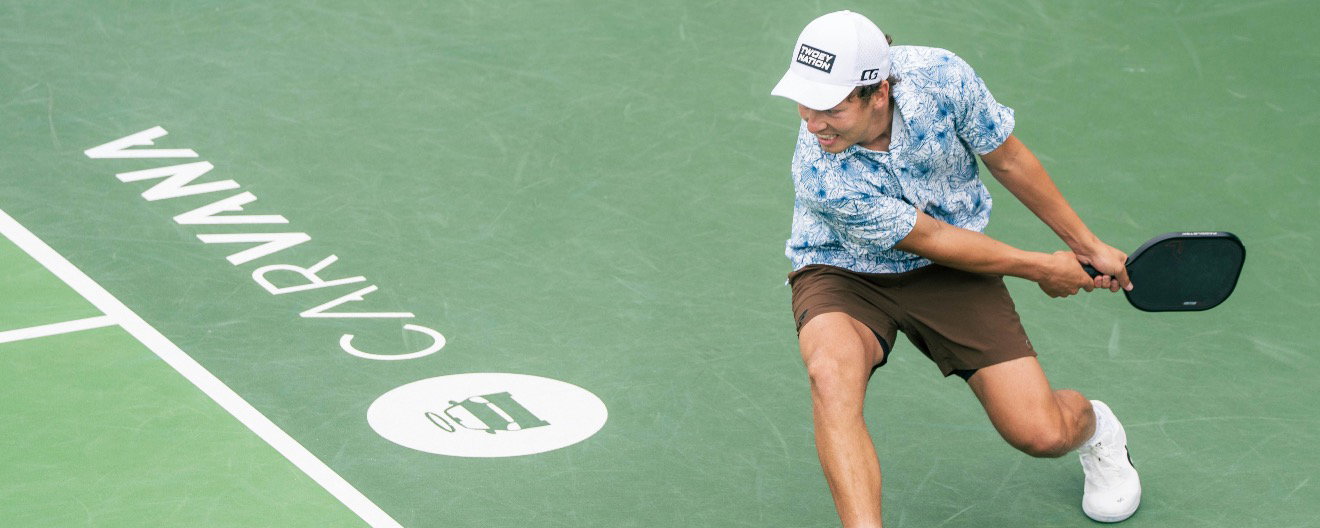 Connor Garnett hitting a two-handed backhand on the pickleball court
