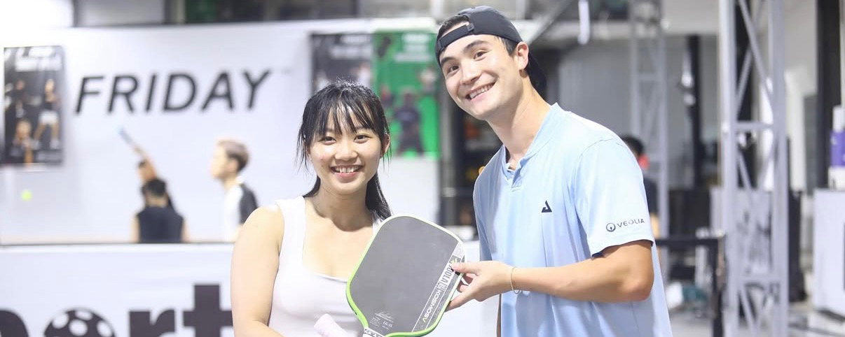 Caden coaching a pickleball player in Ho Chi Minh City, Vietnam