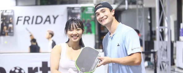 Caden coaching a pickleball player in Ho Chi Minh City, Vietnam