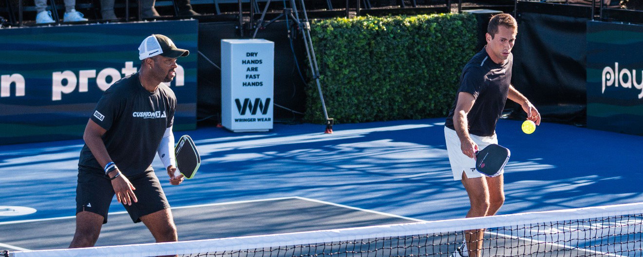 Donald Young and Zane Navratil playing men's doubles pickleball together.