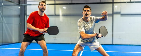 Two men playing pickleball.