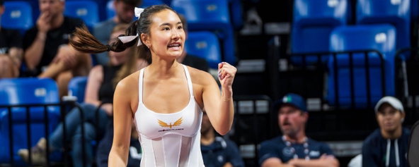 Alix Truong fist pumping while playing pickleball.