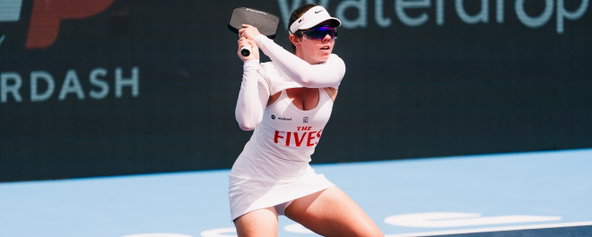 Jorja Johnson hitting a return on the pickleball court.