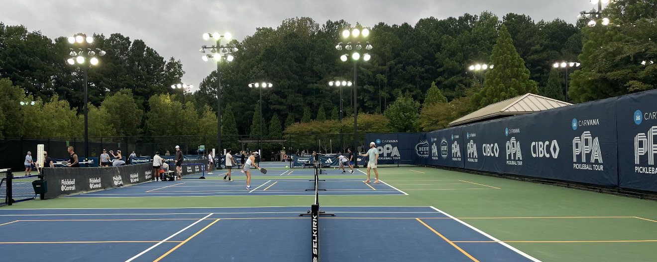 Pickleball courts full of people playing.