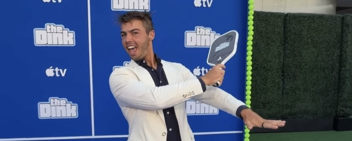 Ben Johns holding a pickleball paddle at 'The Dink' premiere in Los Angeles.