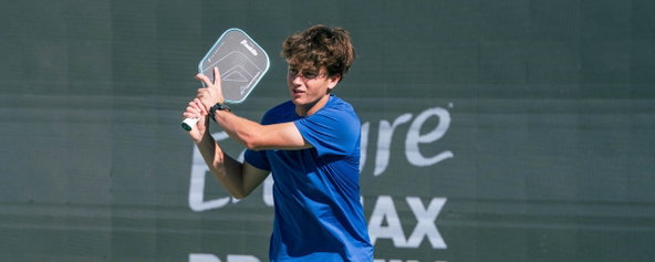 Hayden Patriquin playing pro pickleball with his blue signature paddle.