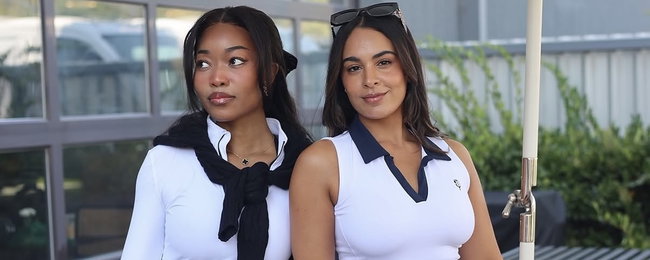 Two girls wearing the women's regatta quarter zip and hamptons polo in white