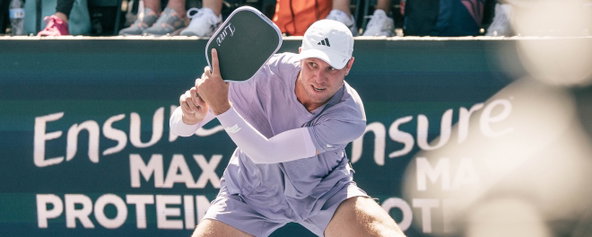 Chris Haworth hitting a two-handed backhand.
