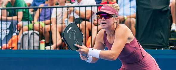 Waters playing with a pickleball paddle with a "?" on it