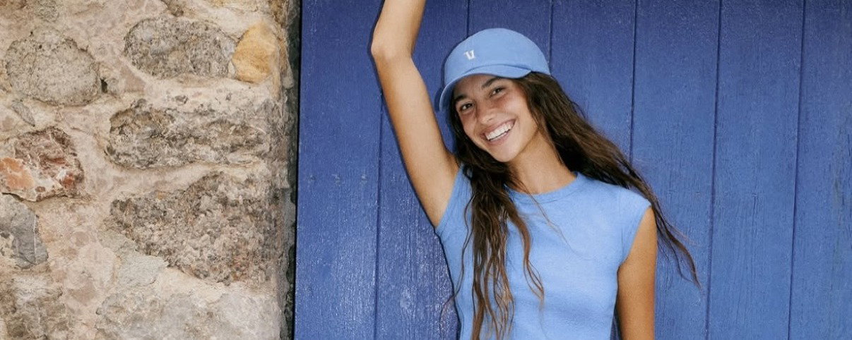 Cleo Bond modeling for Vuori, wearing a blue set.