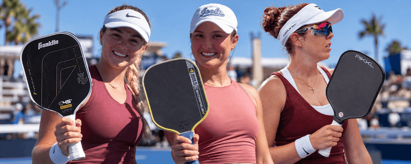 Top female pro pickleball players Anna Leigh Waters, Anna Bright, and Jorja Johnson hold up their pickleball paddles.