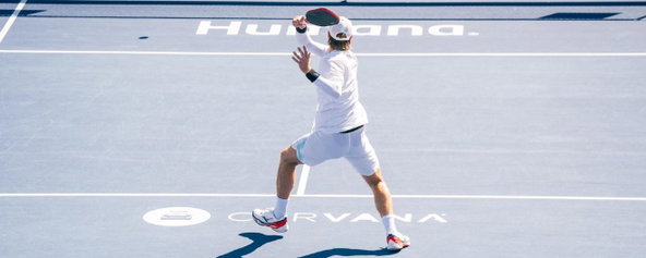 Man in all-white playing singles