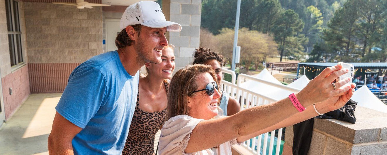 Dow and Angie smiling with a PPA Tour fan taking a selfie